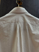 The back of beige shirt showing tailoring details handmade in kl malaysia. 