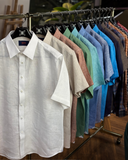 A collection of Albini linen shirts in multiple colours, tailored for style, comfort, and breathable wear in hot climates.