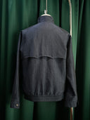 Blue bomber jacket with details at the back.