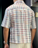 People wearing a checked design shirt made with Indian linen fabric.
