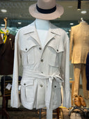 Beige safari coat on a mannequin with a hat with a tie around the waist.