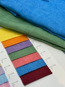 Color swatches of fabric with green and blue linen fabric above.