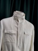 White shirt with 2 buttons in the collar.