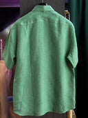 Green shirt made fully bespoke in premium European linen, designed for comfort in hot climates.
