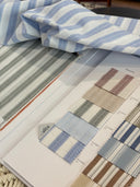 Albini fabrics 'Seersucker' swatches with blue and white striped pattern on a fabric sample book