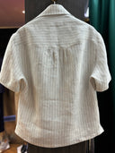 The back view of a hollywood style light-colored striped shirt.