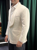 Man wearing a simple yet classic white blazer over a white collar shirt in WH Bespoke located in Wisma UOA2, Kuala Lumpur.
