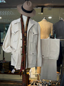 Mannequin wearing a light gray safari jacket, with matching pants beside.