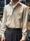 Person wearing a light-colored button-up shirt in WH Bespoke, the best tailor in malaysia.