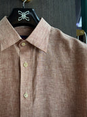 Close up of Albini linen short-sleeve shirts in brick shades near Grand Millennium Hotel