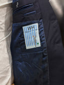 Suit jacket with navy natural material lining with WH Bespoke brand label