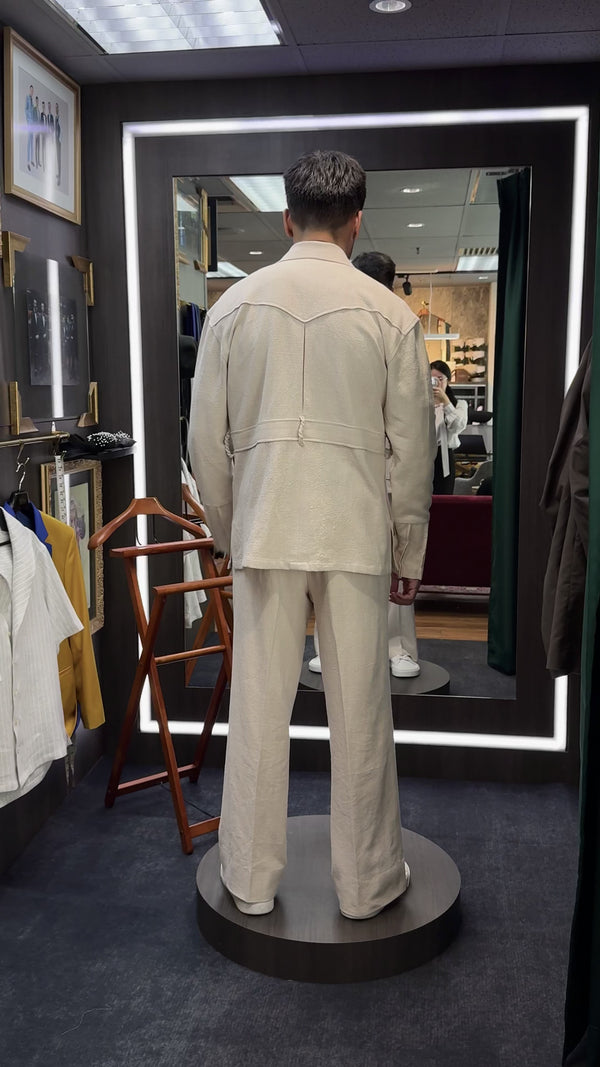 The back view of customer wearing safari jacket and trouser set in kuala lumpur wisma uoa2.