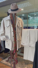 Safari jackets and trousers with accesories like hat and long scarf.