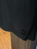 Close-up of a black suit jacket with 2 horn buttons
