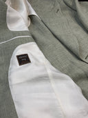 Wide peak lapels on a sage green bespoke suit